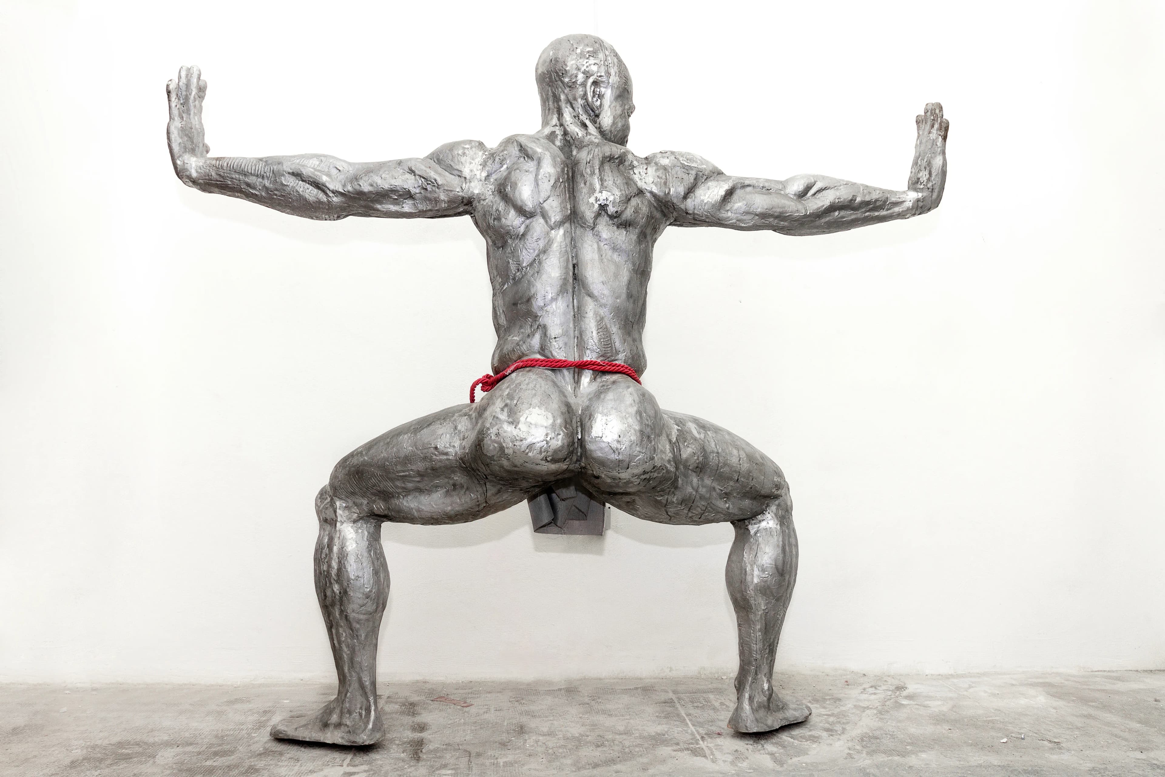 Infinity: a 218 cm tall aluminium sculpture of a Nigerian man crouching with hands outstretched