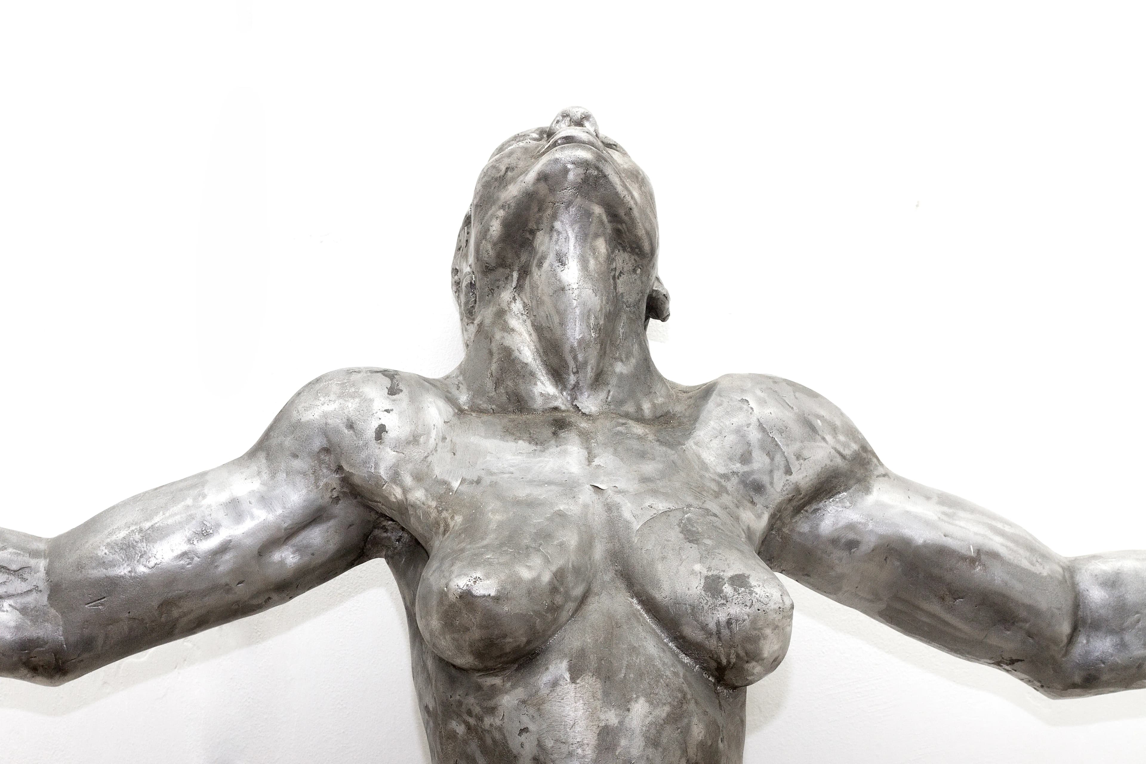 Sacrifice: a 186cm tall aluminium sculpture of a strong, beautiful woman with her hands outstretched